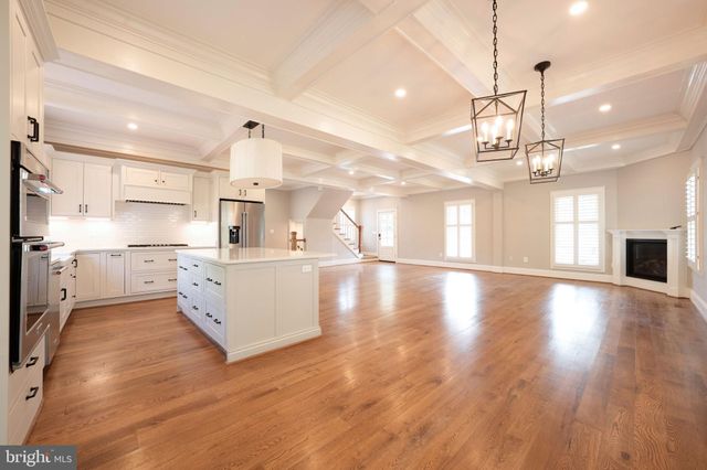 a kitchen with granite countertop cabinets stainless steel appliances and window