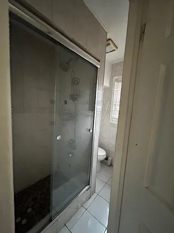 a bathroom with a glass door shower