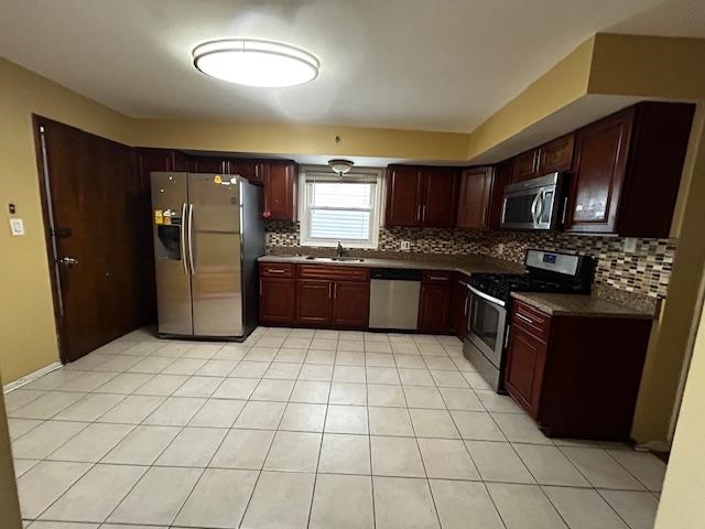 622 Liberty Avenue, Unit 1 Jersey City, NJ 07307 - Photo 14 of 14 a kitchen with stainless steel appliances granite countertop a stove a sink and a refrigerator