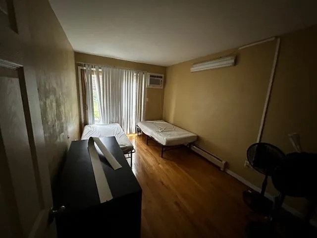 a bedroom with a bed and a window