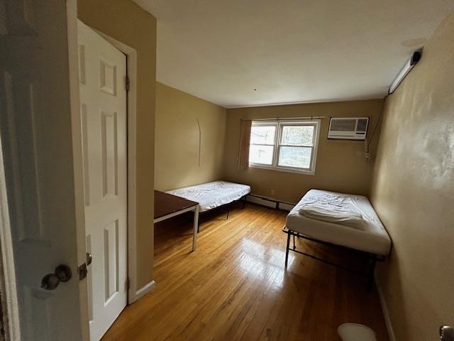 622 Liberty Avenue, Unit 1 Jersey City, NJ 07307 - Photo 9 of 14 a bedroom with furniture and a window