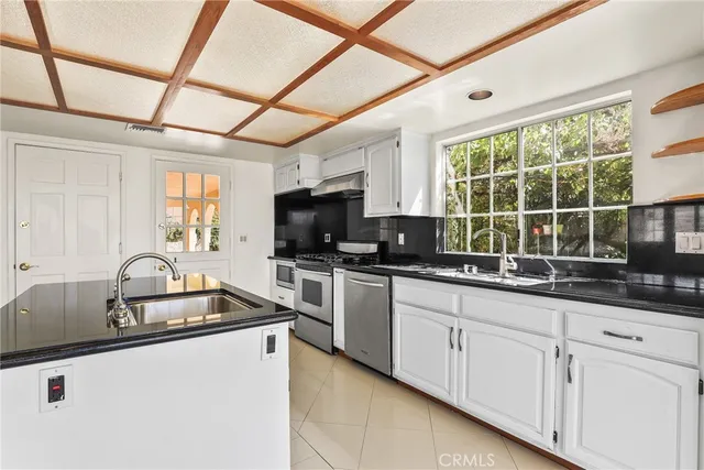 a kitchen with granite countertop a sink and a window