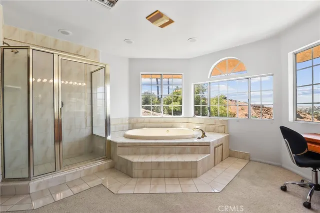 a bathroom with a tub and a window