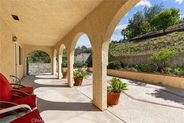 a view of a patio with couches and table and chairs next to yard