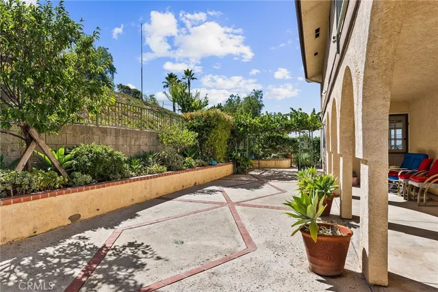 a view of a path along with potted plants