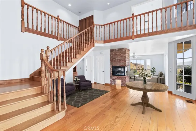 a view of entryway livingroom and hall with wooden floor