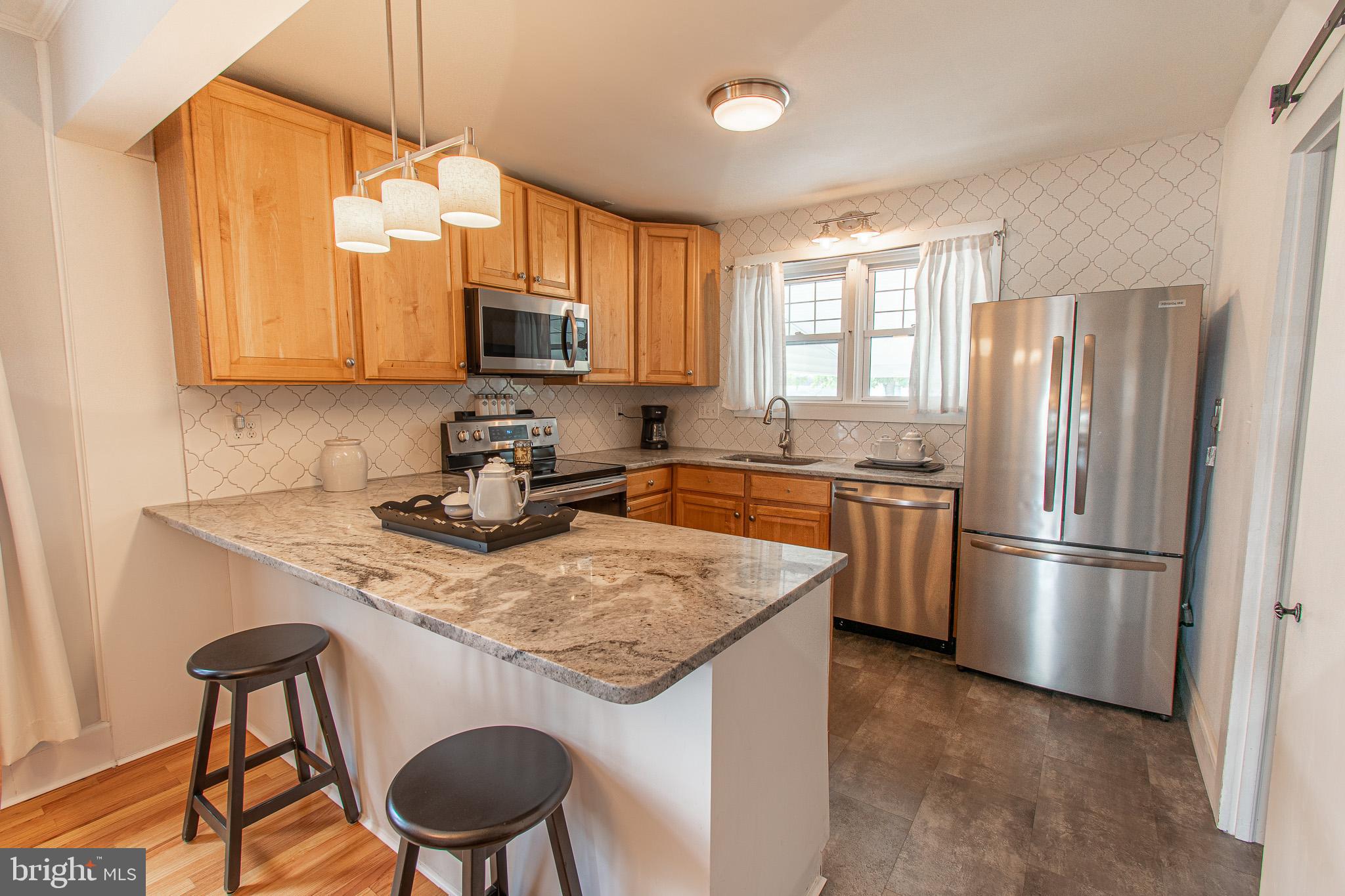 207 Crusader Road Cambridge, MD 21613 - Photo 27 of 76 a kitchen with a refrigerator a stove a sink and a cabinets