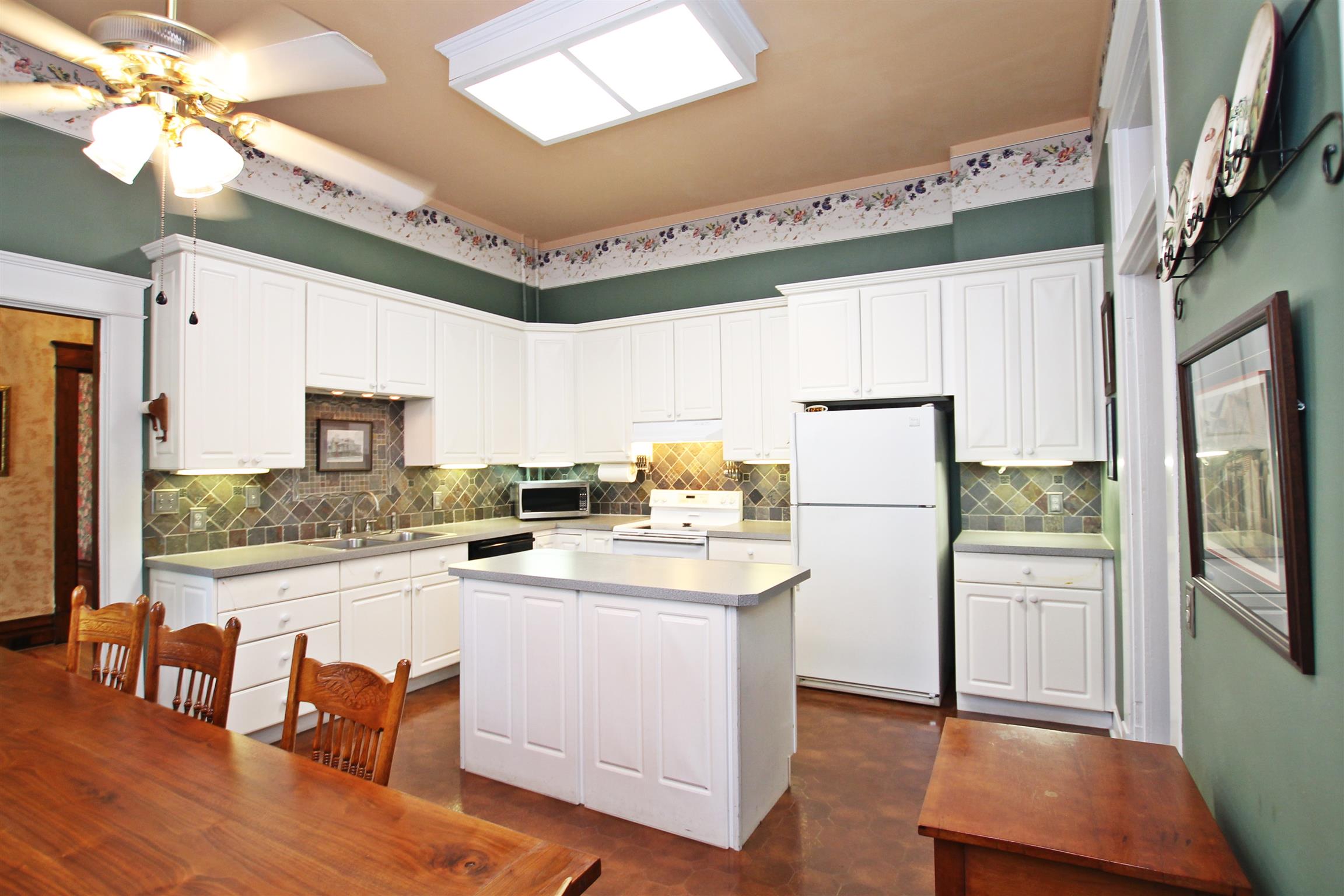 307 North Main Street Springfield, TN 37172 - Photo 8 of 30 a kitchen with a refrigerator a stove a sink dishwasher a dining table and chairs with wooden floor