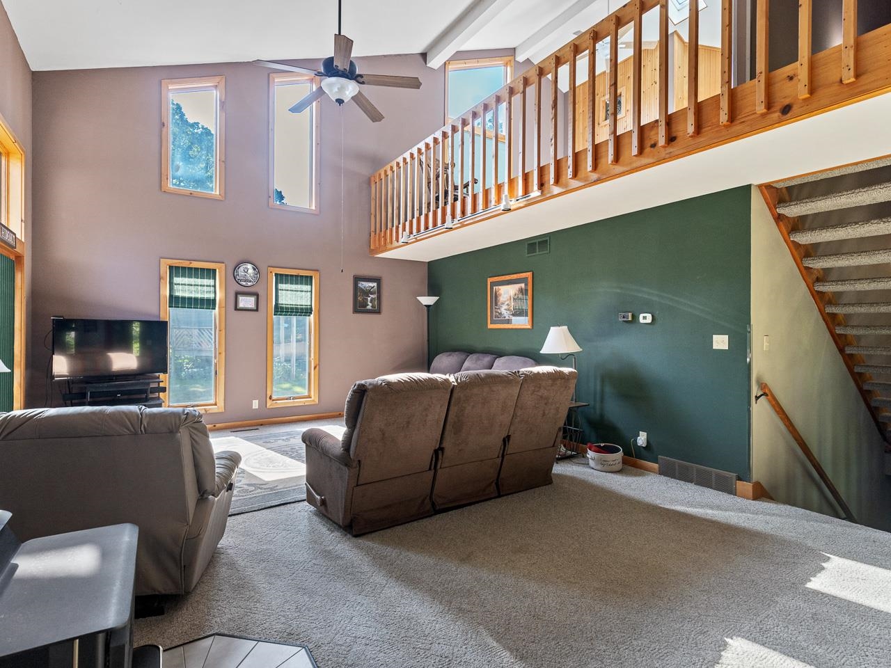 1 Lake Summerset Road Lake Summerset, IL 61019 - Photo 17 of 41 a living room with furniture a flat screen tv and a fireplace