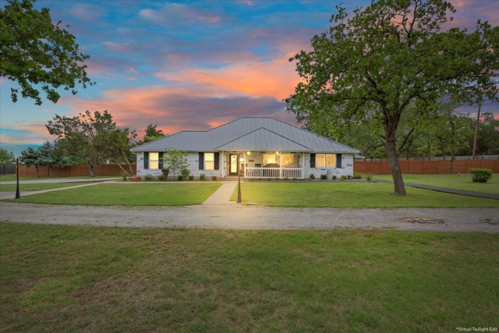 Ranch-style home featuring a porch and driveway