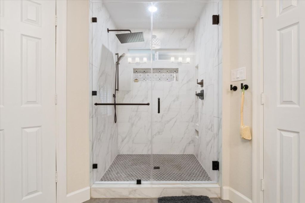 190 Young Ranch Road Georgetown, TX 78633 - Photo 13 of 40 Bathroom with a marble finish shower and baseboards