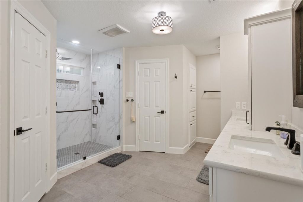190 Young Ranch Road Georgetown, TX 78633 - Photo 15 of 40 Bathroom featuring double vanity and a marble finish shower