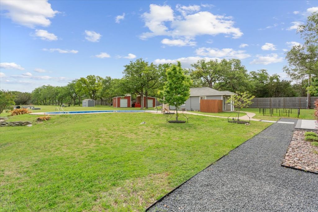 190 Young Ranch Road Georgetown, TX 78633 - Photo 24 of 40 View of green lawn featuring an outbuilding