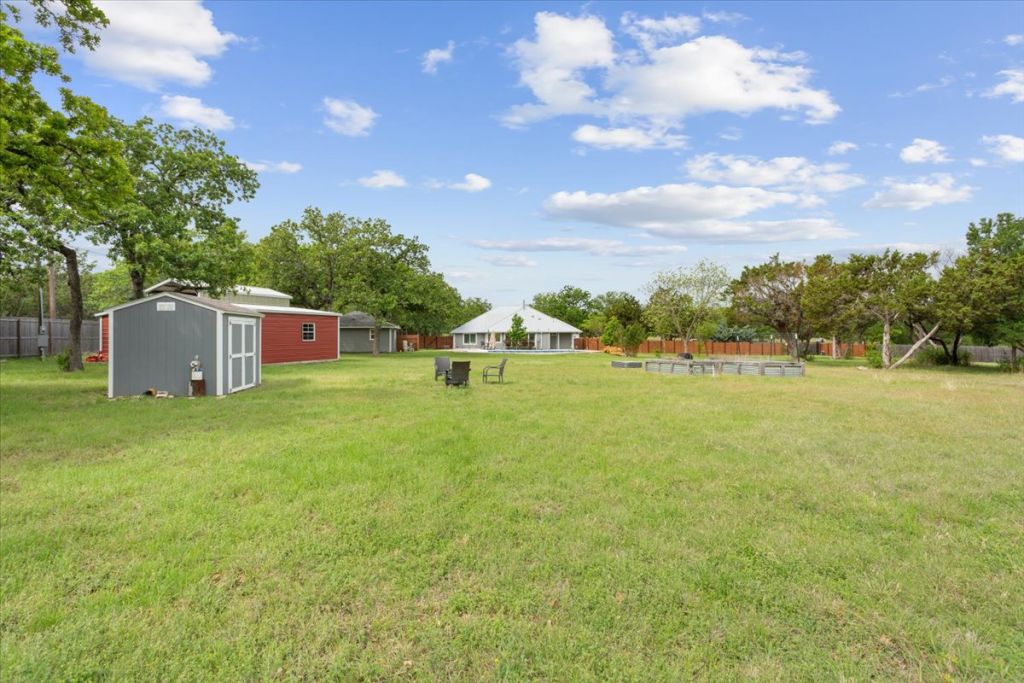 190 Young Ranch Road Georgetown, TX 78633 - Photo 25 of 40 View of yard featuring a shed and view of scattered trees
