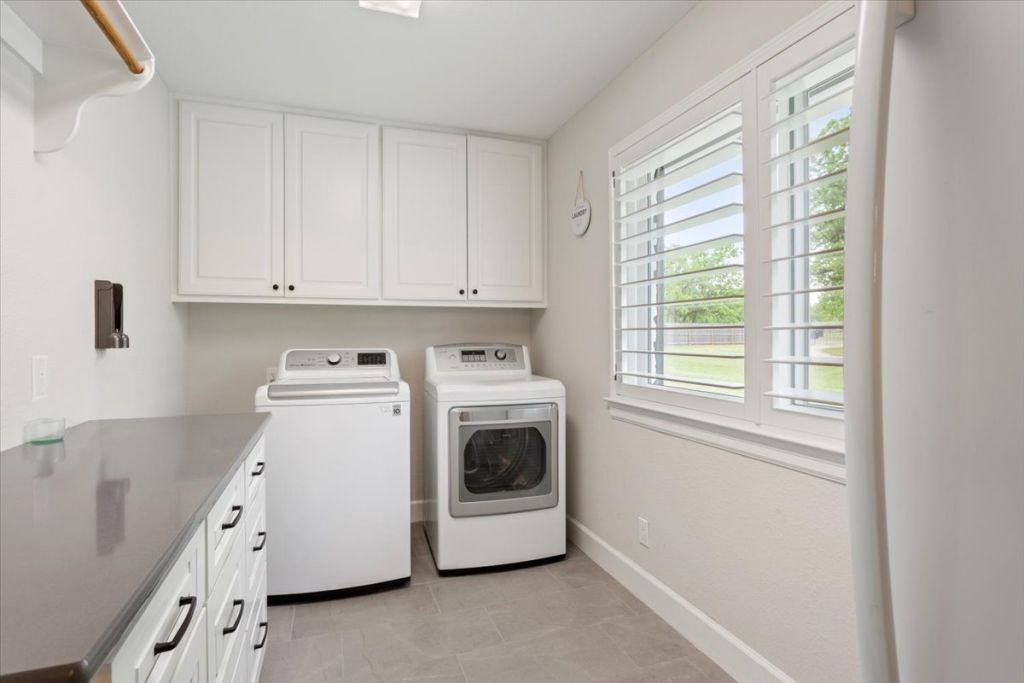 190 Young Ranch Road Georgetown, TX 78633 - Photo 36 of 40 Laundry room with cabinet space, separate washer and dryer, and light tile patterned floors