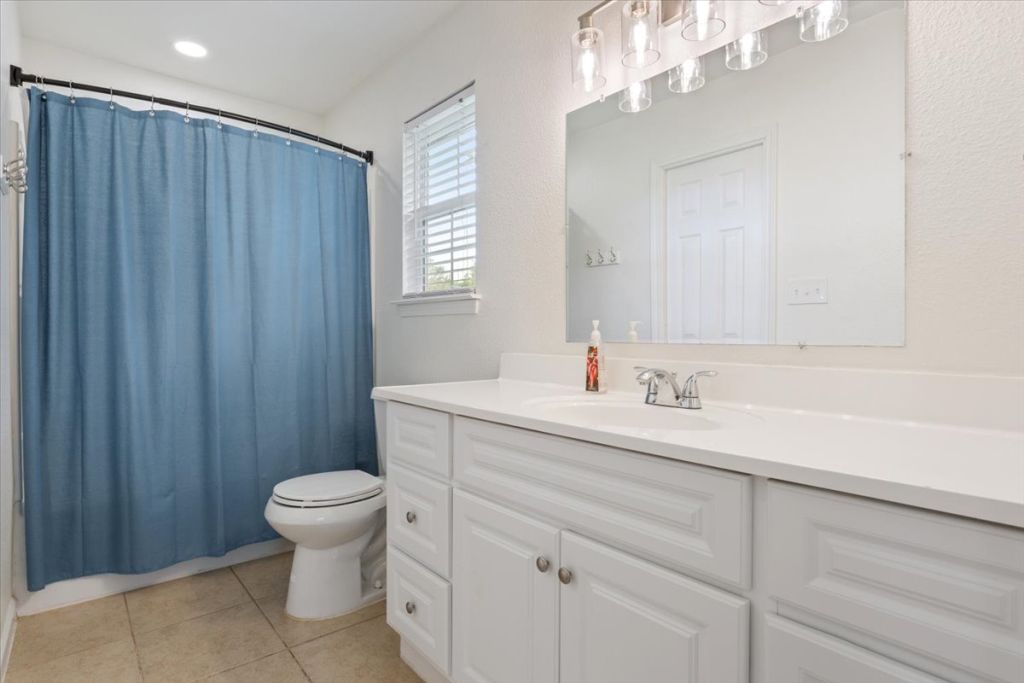 190 Young Ranch Road Georgetown, TX 78633 - Photo 38 of 40 Full bathroom with vanity and light tile patterned floors