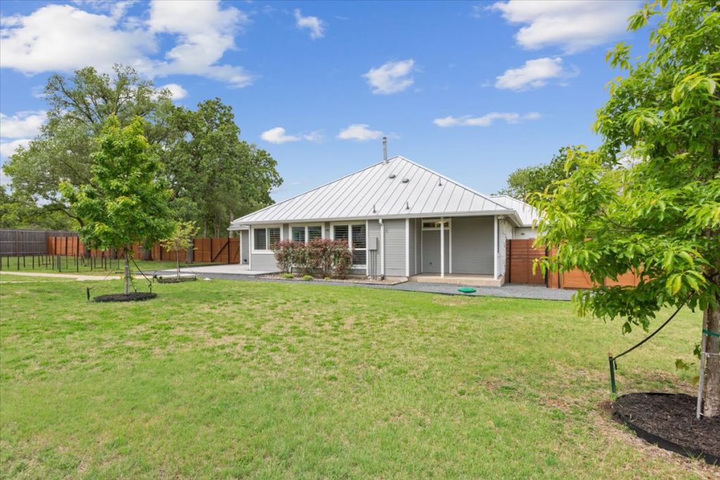 190 Young Ranch Road Georgetown, TX 78633 - Photo 39 of 40 Rear view of house with a fenced backyard, a patio area, and a standing seam roof