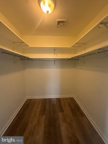 a view of a room with wooden floor and a window