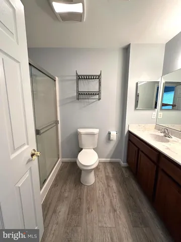 a bathroom with a toilet a sink and a mirror