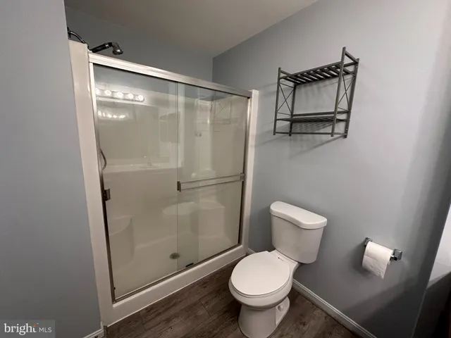 a bathroom with a toilet and a shower