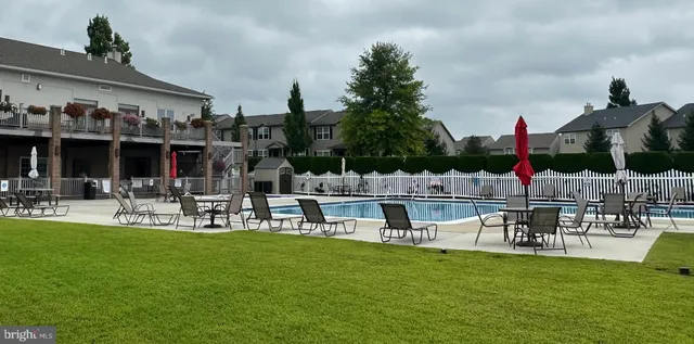 a view of swimming pool with seating area and hardwood floor