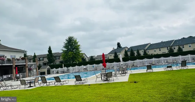 a view of a swimming pool with a garden and lake view