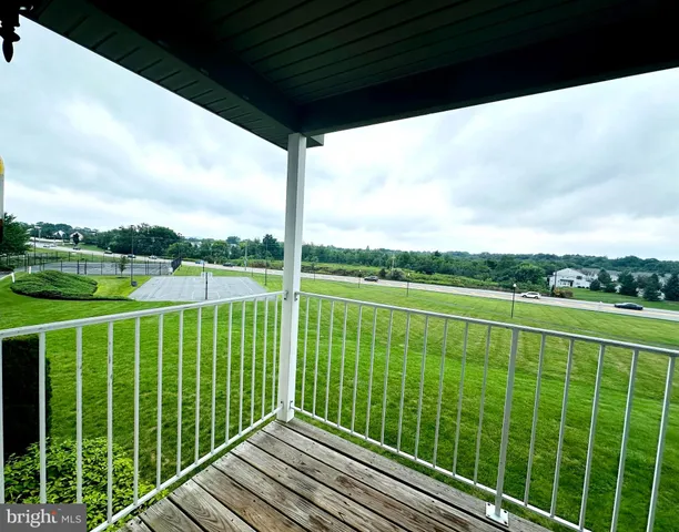 a view of a balcony with a yard