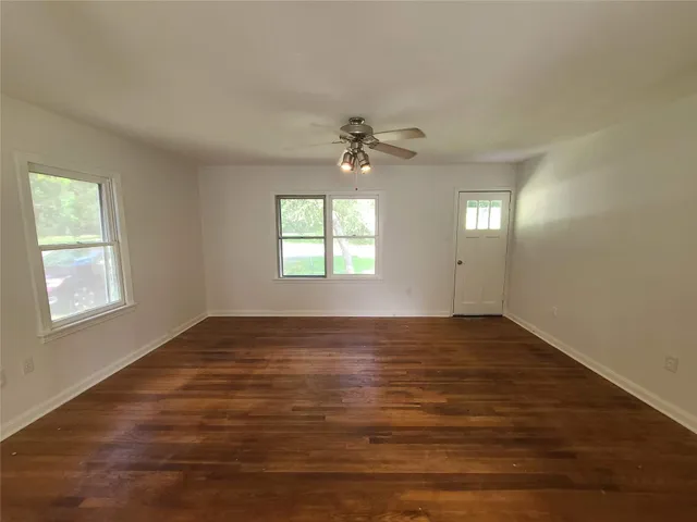 wooden floor in an empty room with a window