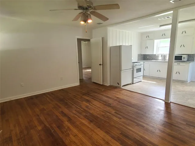 a view of a kitchen with wooden floor and a sink