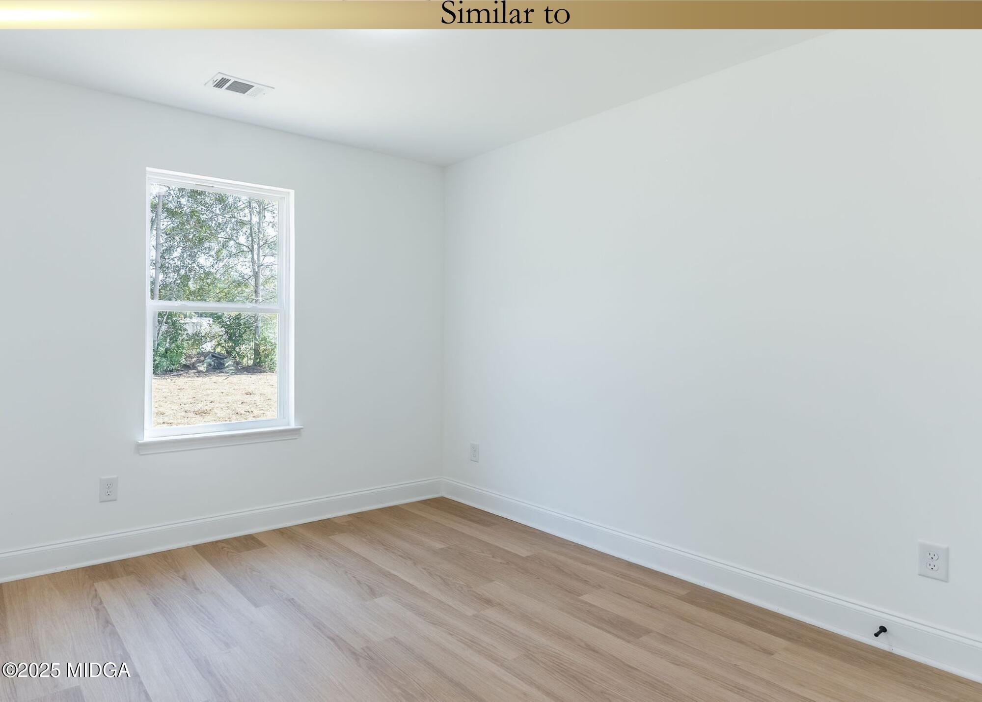 106 Maries Gdn Trail Macon, GA 31216 - Photo 19 of 19 an empty room with wooden floor and windows