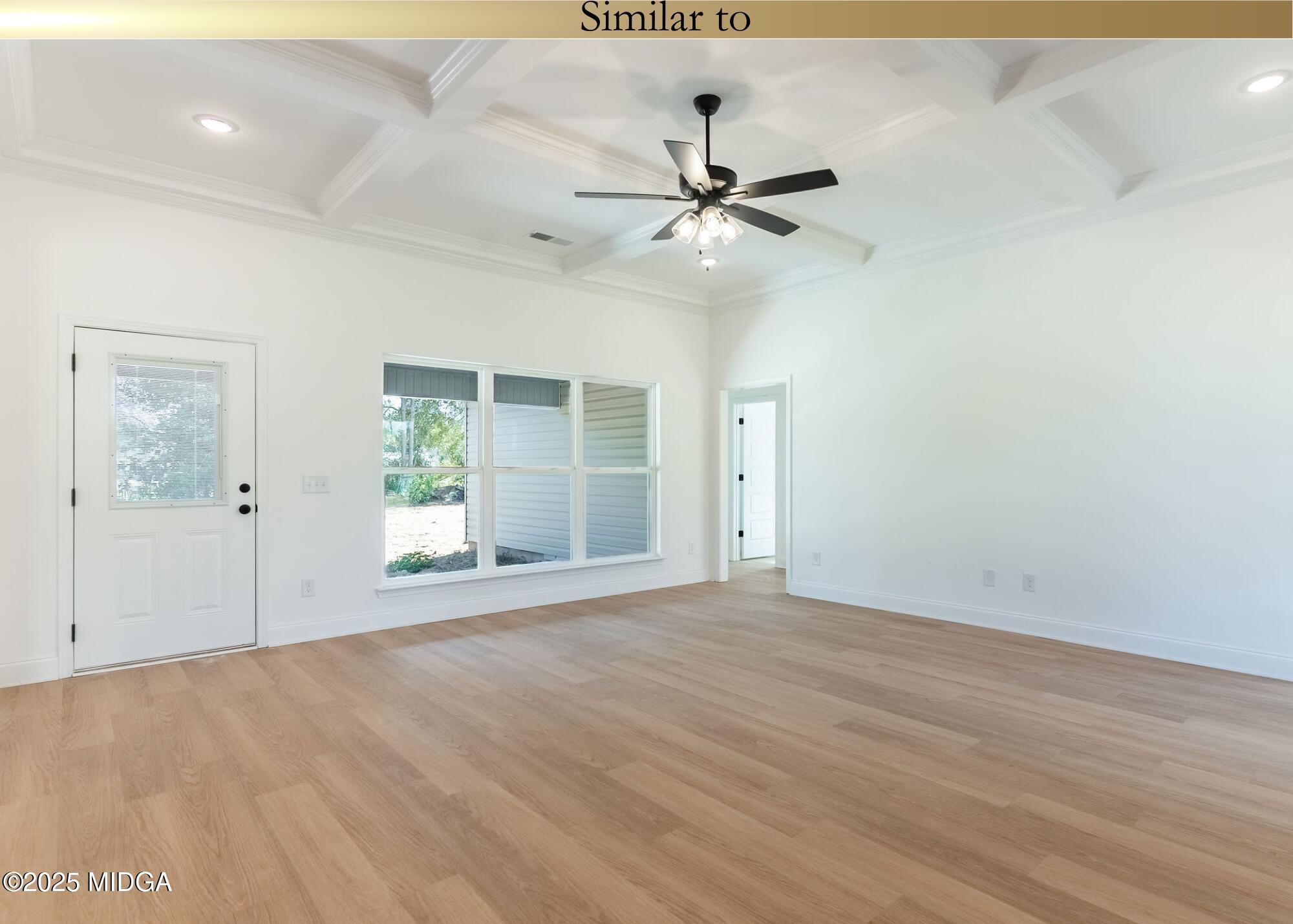 106 Maries Gdn Trail Macon, GA 31216 - Photo 2 of 19 an empty room with wooden floor fan and windows