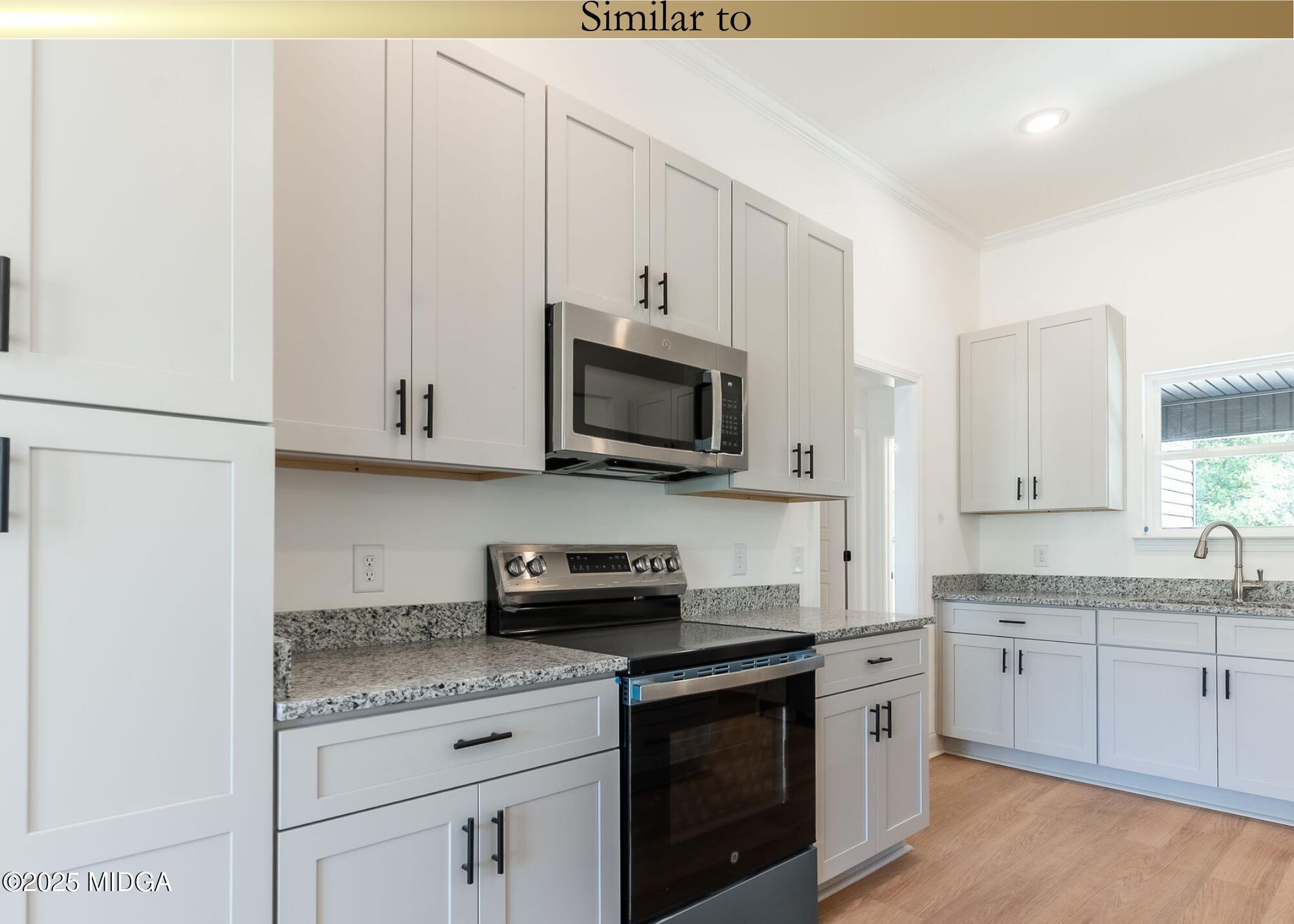 106 Maries Gdn Trail Macon, GA 31216 - Photo 4 of 19 a kitchen with stainless steel appliances granite countertop a sink a stove a microwave and cabinets