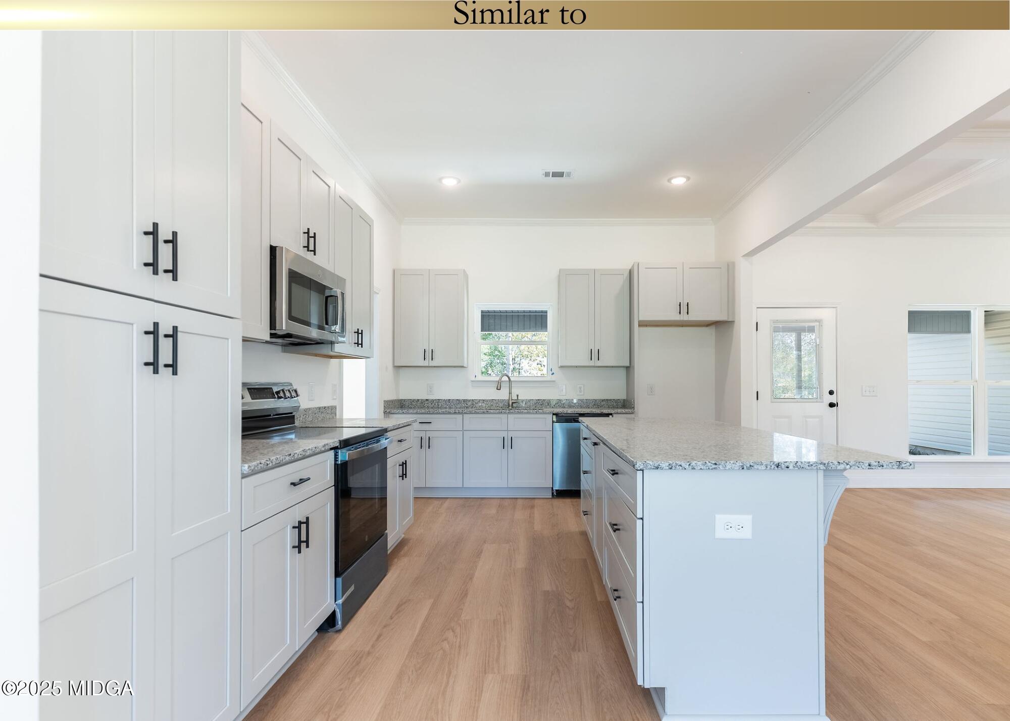 106 Maries Gdn Trail Macon, GA 31216 - Photo 6 of 19 a large kitchen with stainless steel appliances lots of counter space and wooden floor