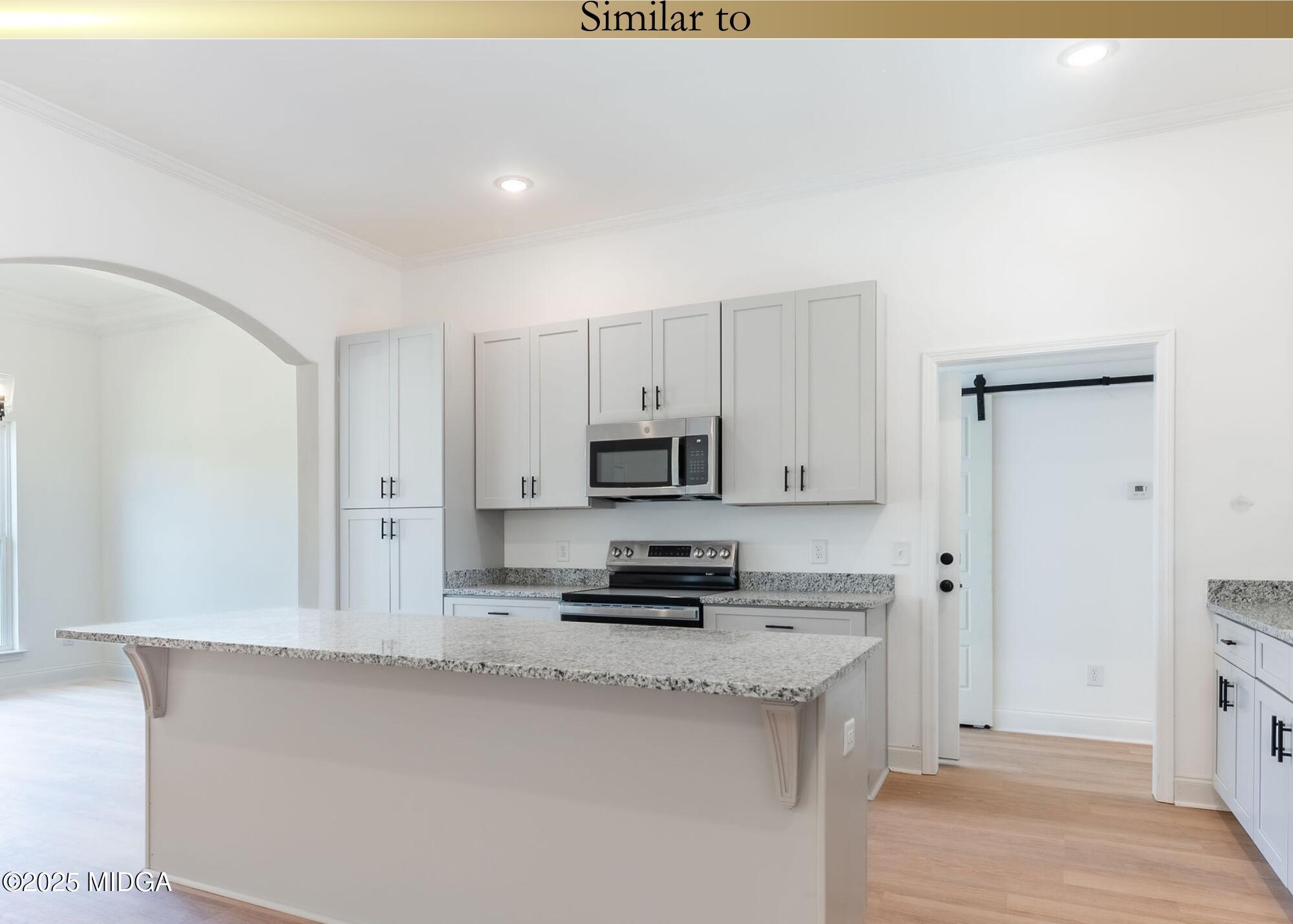106 Maries Gdn Trail Macon, GA 31216 - Photo 7 of 19 a kitchen with stainless steel appliances a stove a microwave a sink and cabinets