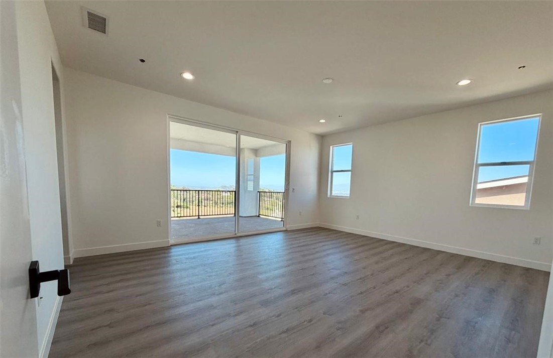 16765 La Bella Villa Riverside, CA 92503 - Photo 12 of 27 an empty room with wooden floor and windows