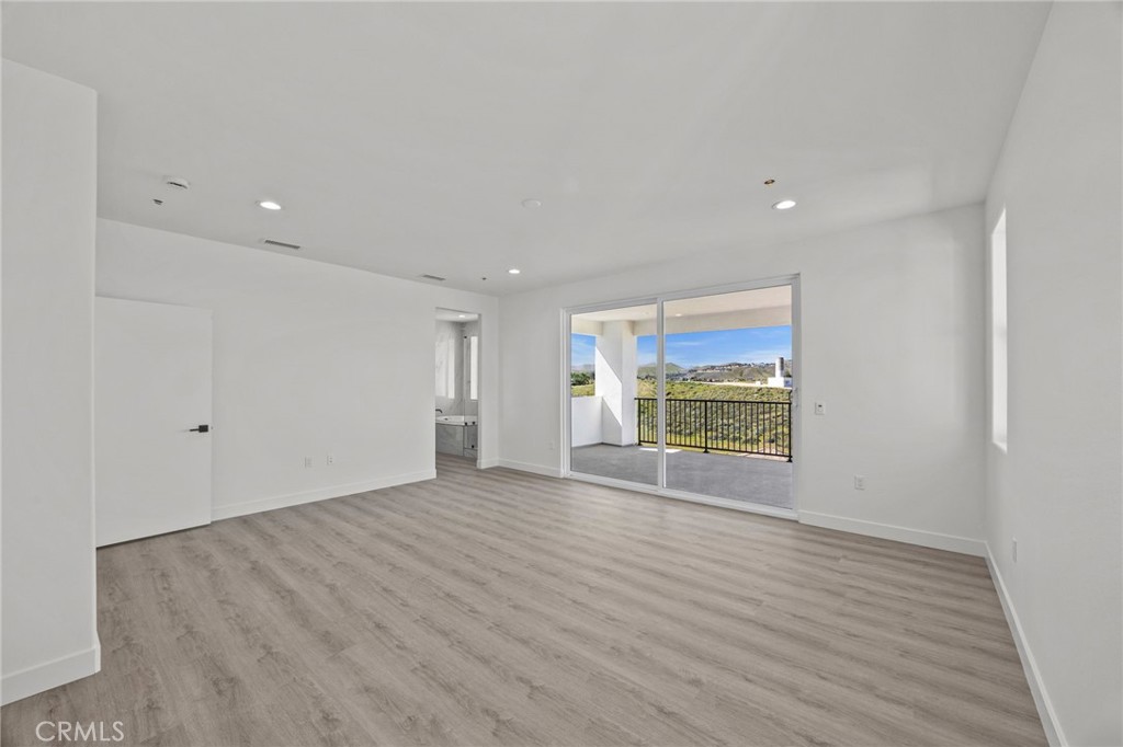 16765 La Bella Villa Riverside, CA 92503 - Photo 14 of 27 a view of an empty room with wooden floor and a window