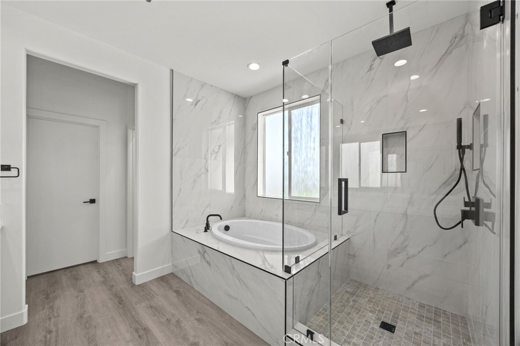 16765 La Bella Villa Riverside, CA 92503 - Photo 15 of 27 a bathroom with a tub shower vanity and a sink