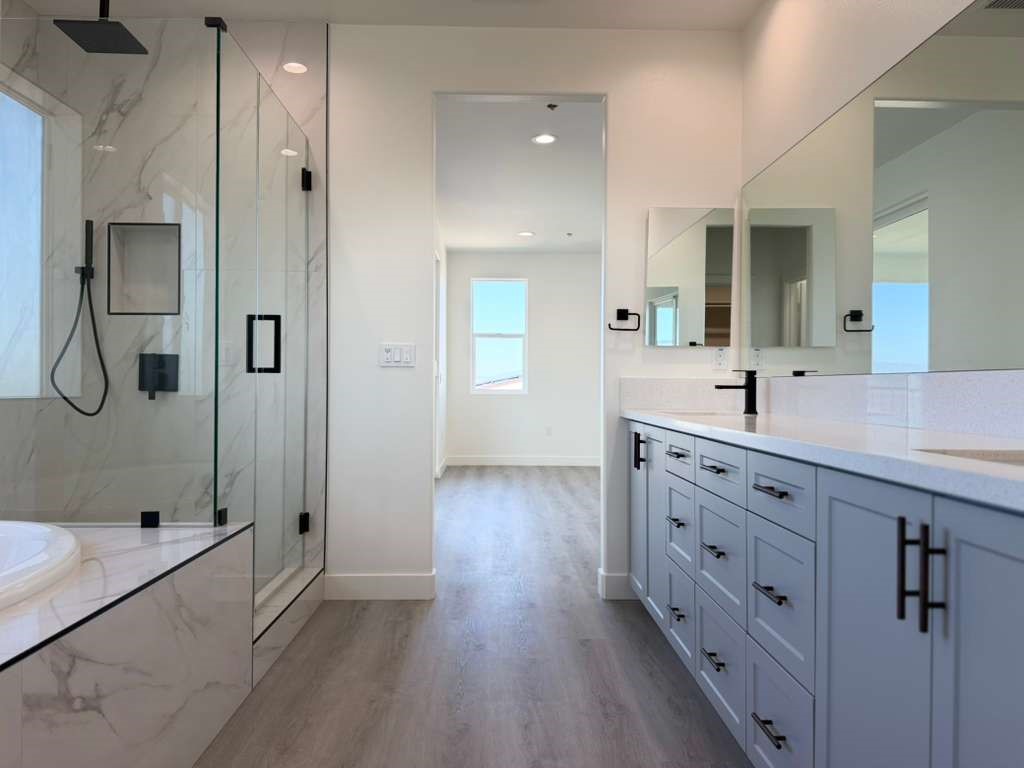 16765 La Bella Villa Riverside, CA 92503 - Photo 16 of 27 a spacious bathroom with double vanity a glass shower door and a mirror