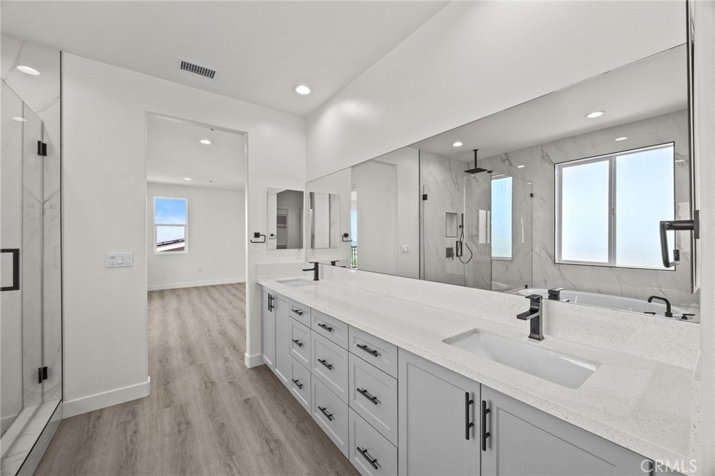 16765 La Bella Villa Riverside, CA 92503 - Photo 17 of 27 a spacious bathroom with double vanity and mirrors
