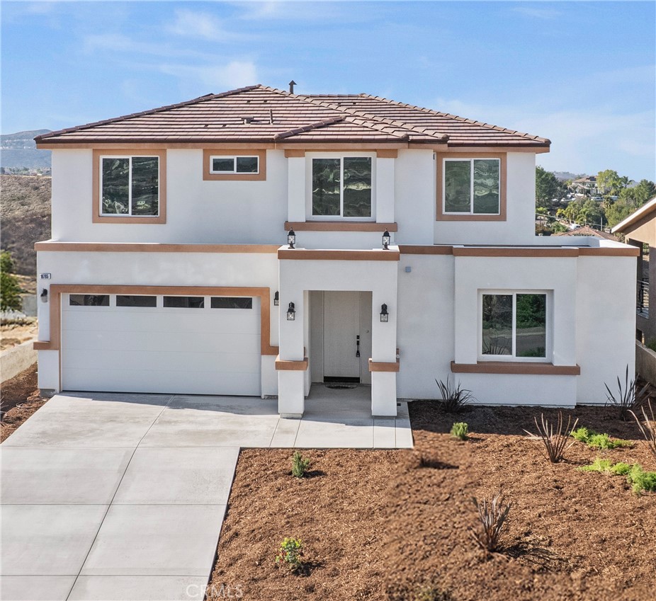 16765 La Bella Villa Riverside, CA 92503 - Photo 3 of 27 a front view of a house with a yard and garage