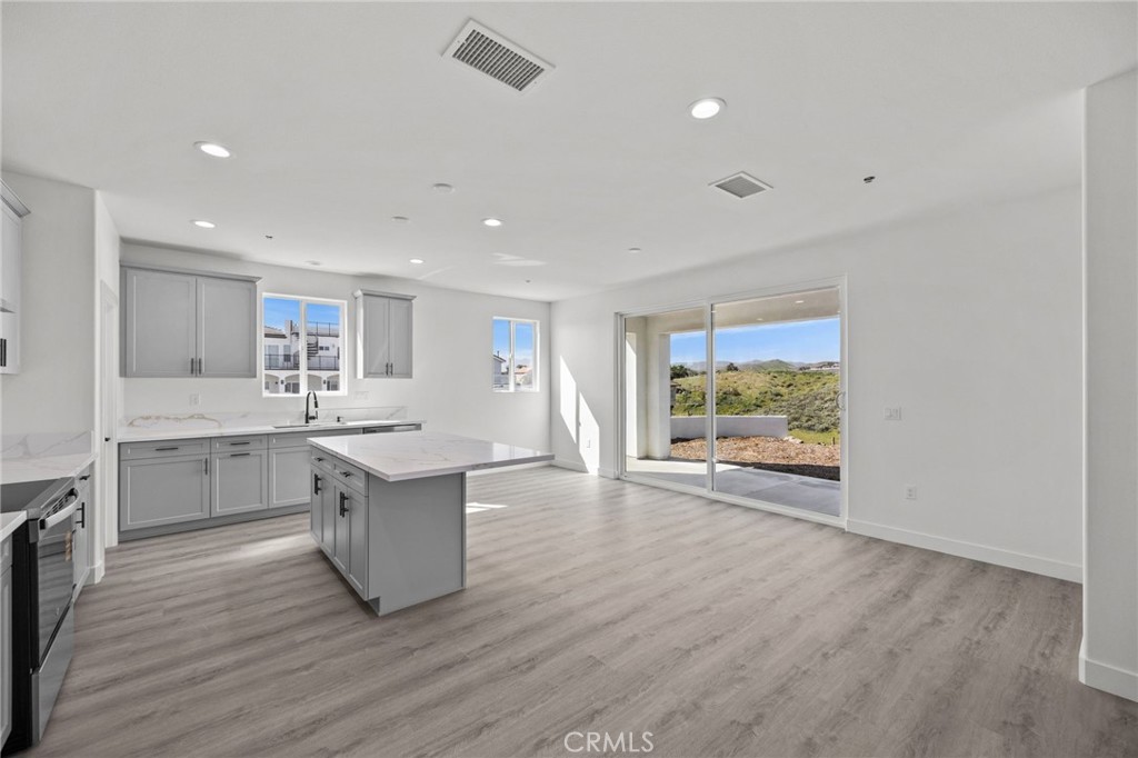 16765 La Bella Villa Riverside, CA 92503 - Photo 4 of 27 a large kitchen with a table and chairs in it