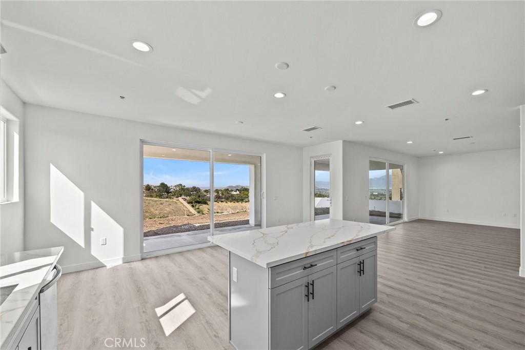 16765 La Bella Villa Riverside, CA 92503 - Photo 7 of 27 a large kitchen with stainless steel appliances granite countertop a large stove a sink and a large window
