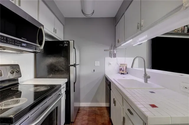 a kitchen with a sink stove and refrigerator