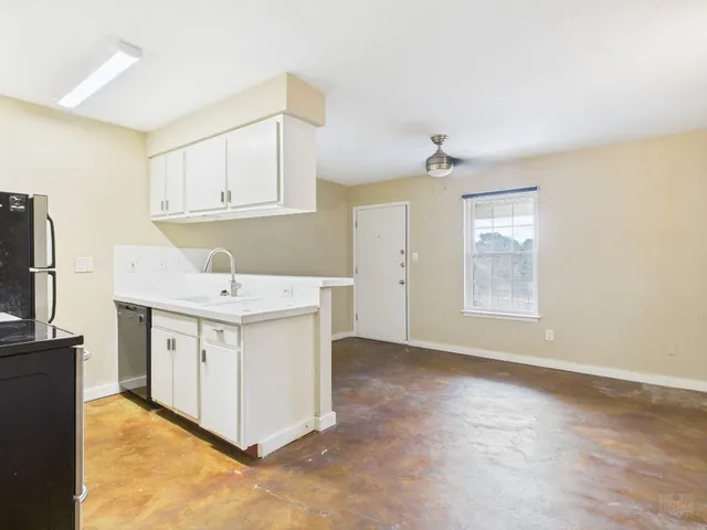 a utility room with cabinets washer and dryer