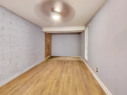 a view of room with wooden floor