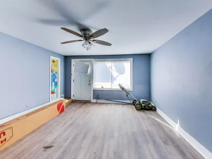 a big room with wooden floor and windows