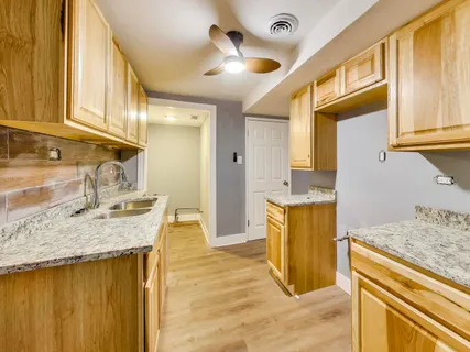 a bathroom with a granite countertop sink and a mirror