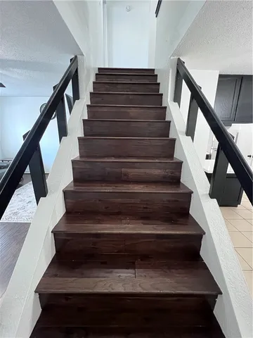 a bed sitting in a bedroom next to a window and a chandelier