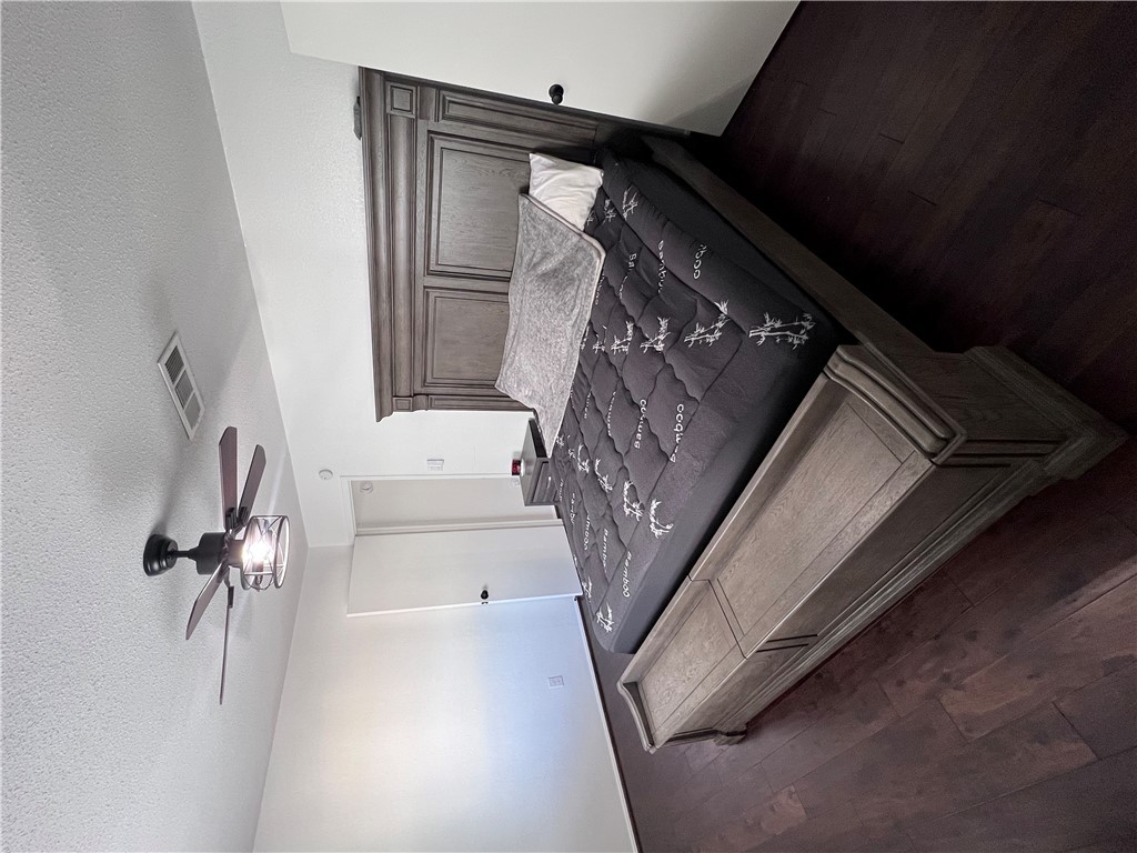 4507 Carter Creek Parkway, Unit 2 Bryan, TX 77802 - Photo 13 of 26 a bed sitting in a bedroom next to a window and a chandelier