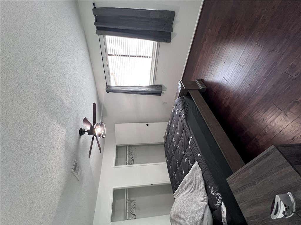 4507 Carter Creek Parkway, Unit 2 Bryan, TX 77802 - Photo 14 of 26 a bedroom with a bed and wooden floor